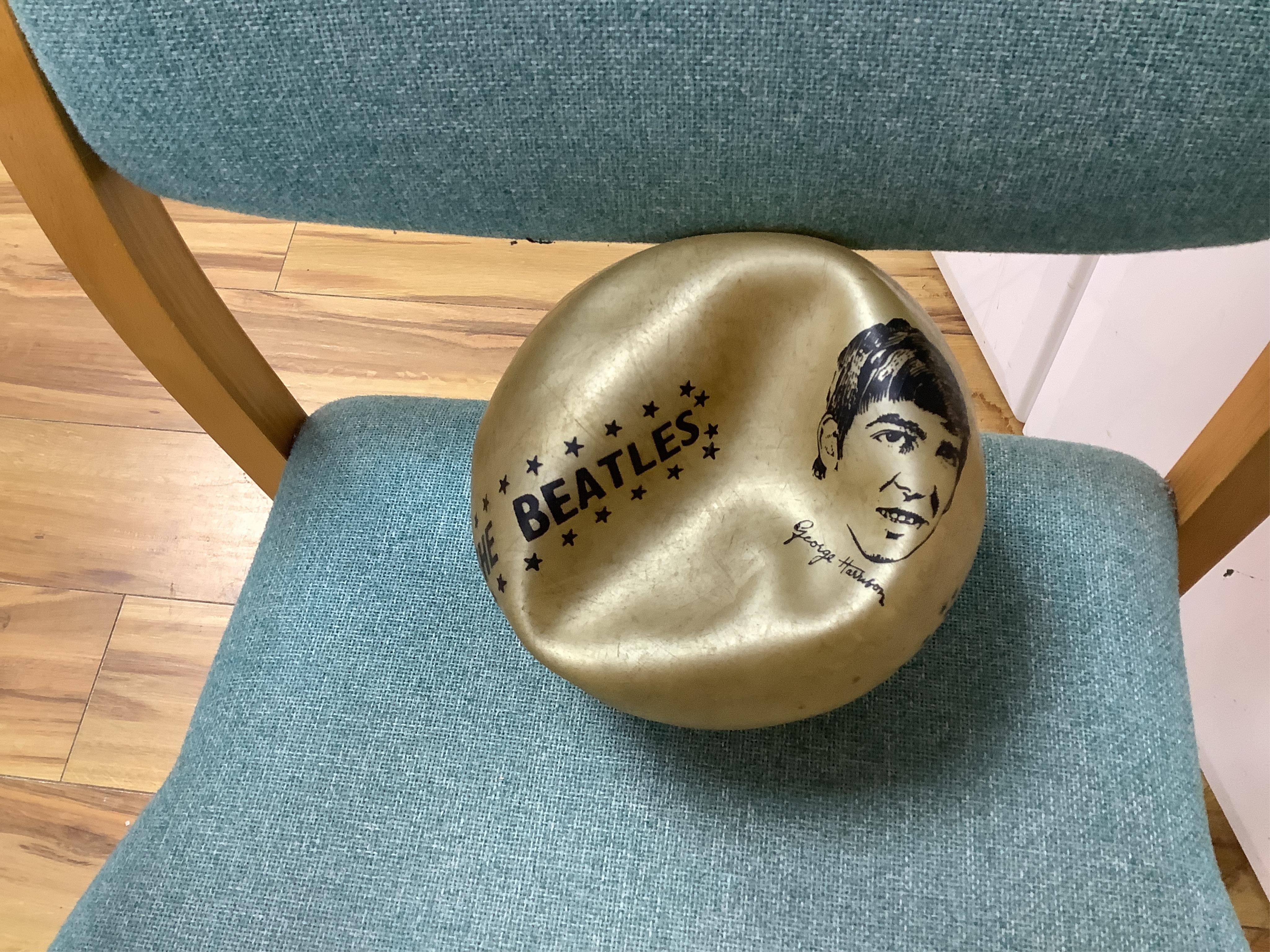 A 1960's Beatles child's plastic drum set in the original card box comprising of a snare drum on a stand, a card cut out bust of Ringo Starr, two 1960s Beatles jigsaws (unchecked) and a Beatles inflatable ball